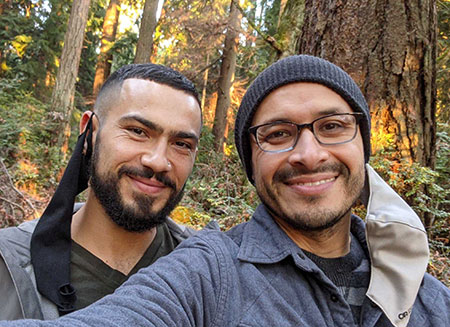 A gay Latinx couple enjoying an autumn hike