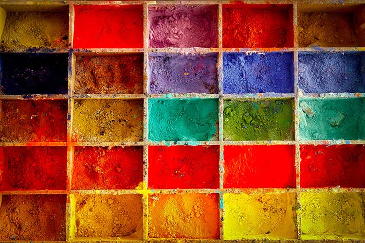 Tray of powdered paint in vibrant rainbow colors
